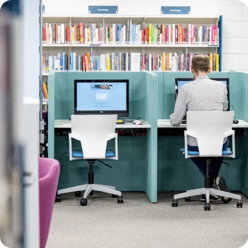 A library user at a computer cubicle