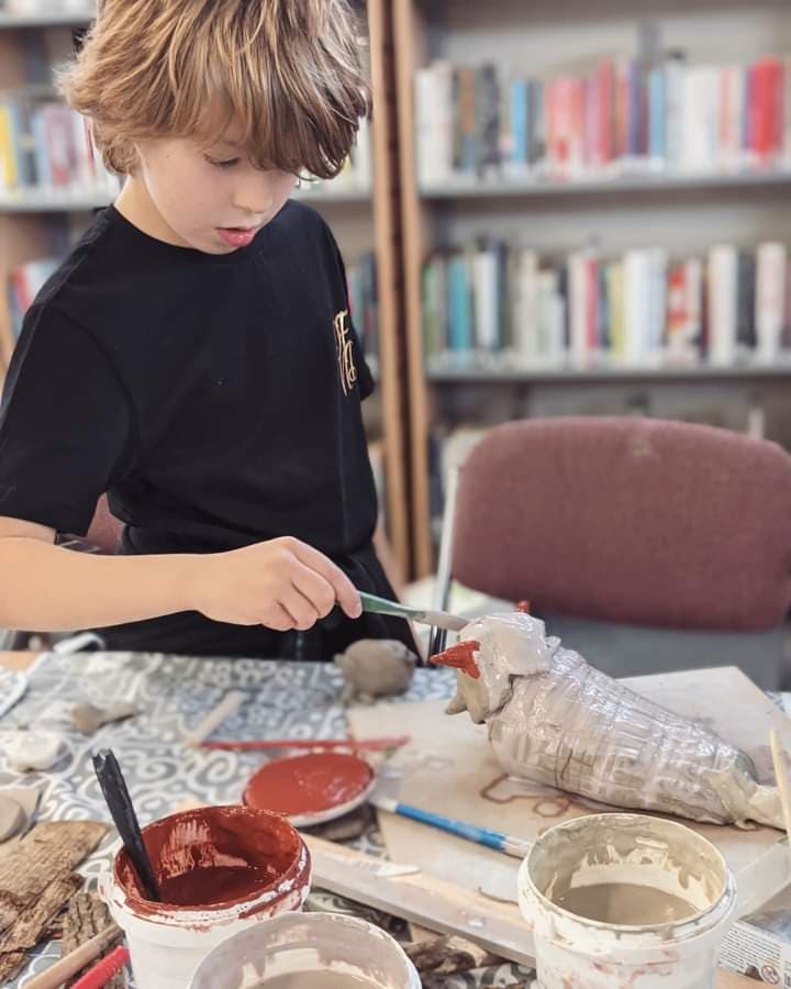 A child doing arts and crafts at a library.